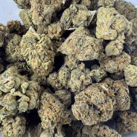 Close-up view of Bubba Kush cannabis buds showcasing their dense, frosty texture and rich green hues.