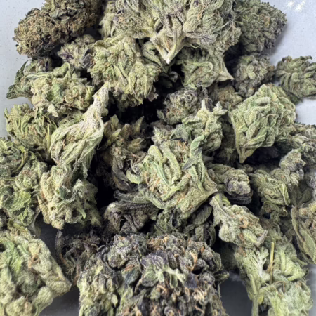 Close-up view of Bubba Kush cannabis buds showcasing their rich green and purple hues, highlighting the unique texture and quality.