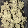 Close-up of Jet Fuel Gelato cannabis buds showcasing their dense, frosty texture and vibrant green hues.
