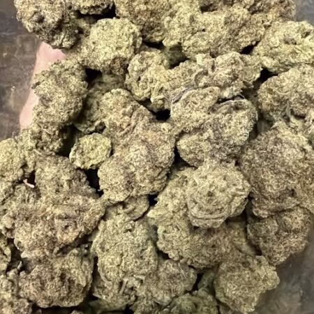 Close-up view of Pink Lemonade cannabis buds showcasing their dense, frosty texture and vibrant green color.