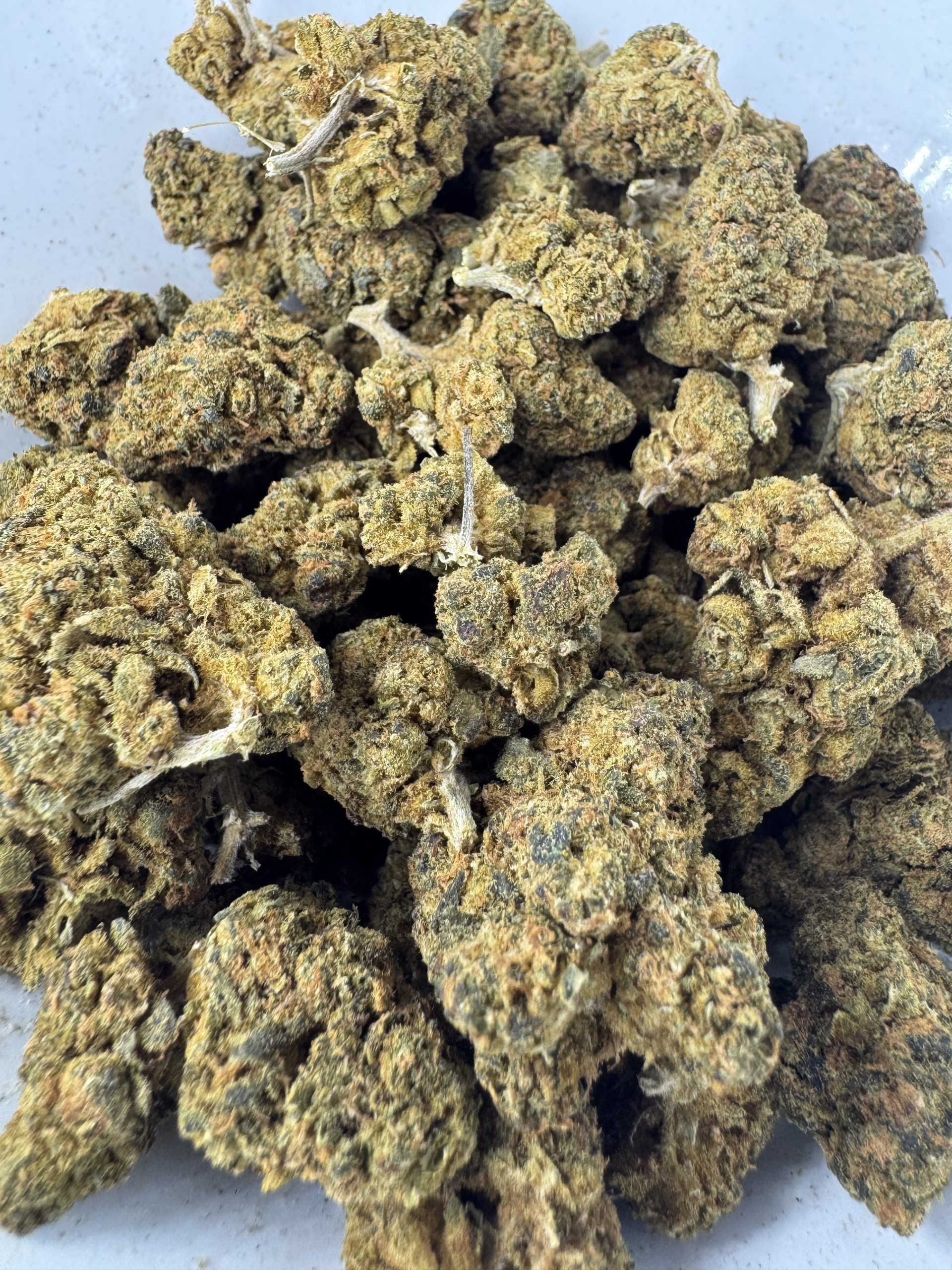 Purple Kush 1 A close-up view of premium Purple Kush cannabis buds, showcasing their dense structure and rich green hues, ideal for connoisseurs seeking quality.