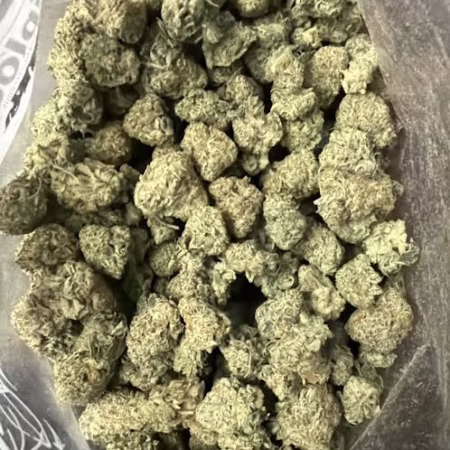 A close-up view of the Forbidden Fruit Cake, showcasing its dense and frosty buds, highlighting its unique texture and color.