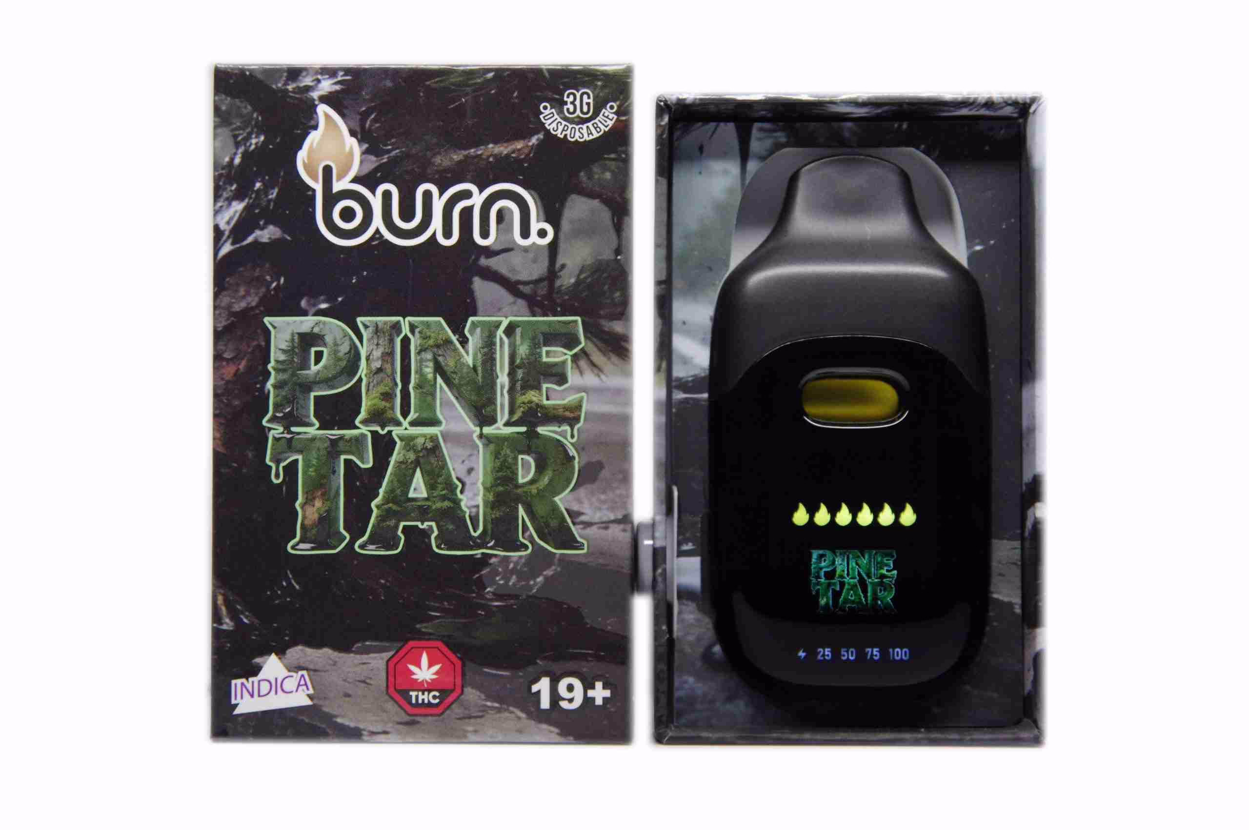 A black Burn Disposable Pen 3g - Pinetar vape device shown next to its branded packaging featuring a forest theme and indica labeling.